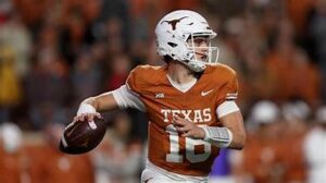“Arch Manning celebrating a touchdown in Texas Longhorns uniform vs Arkansas.”
