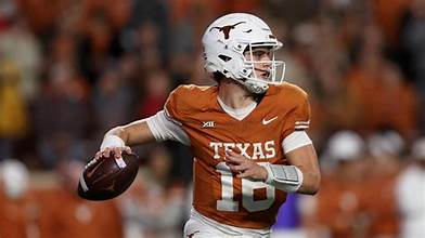 “Arch Manning celebrating a touchdown in Texas Longhorns uniform vs Arkansas.”