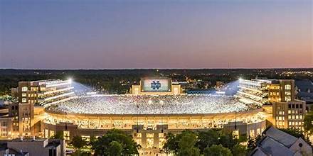 “Notre Dame Stadium exterior on game day with fans entering.”