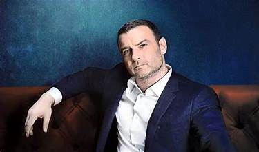 “Liev Schreiber performing on stage in a dramatic play.”