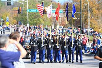 U.S. veterans saluting during a Veterans Day 2025 ceremony with American flags waving in the background — symbolizing honor, sacrifice, and national gratitude