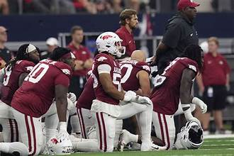 “Arkansas Razorbacks defensive player tackling a Longhorn in a college football game.”