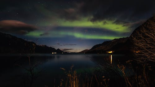 Wide-angle view of northern lights over Wisconsin with distinct green arcs during a strong solar storm.