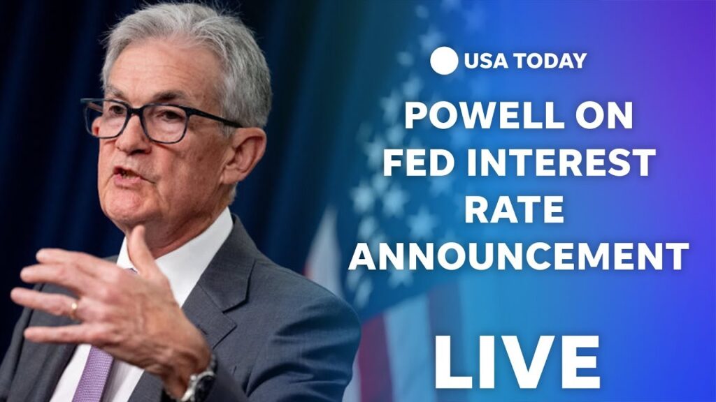 “Federal Reserve chair announcing interest rate decision during press conference.”