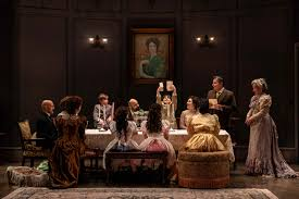 Tom Stoppard standing on stage during a theatre discussion about modern drama and philosophical storytelling.